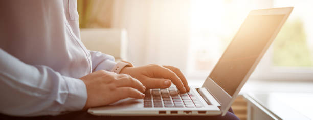 istock Business woman working at laptop, no face 1345174012