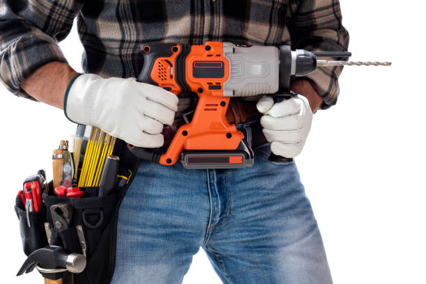 istock Carpenter holding rechargeable hammer drill, isolated on white background. 1345174016