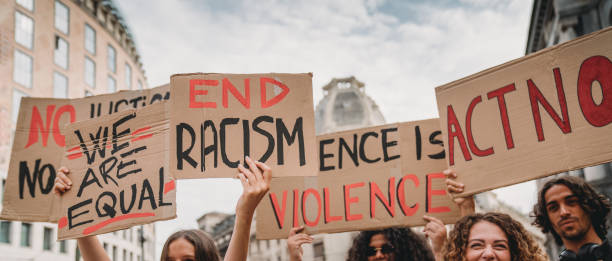 People are marching on strike against racism People are marching on strike against racism in the city. They are holding cardboard signs. prejudice stock pictures, royalty-free photos & images