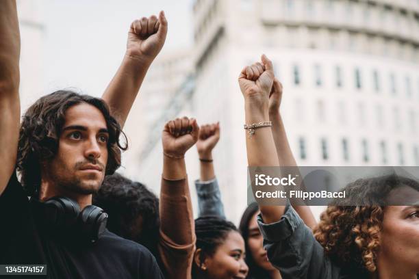 People With Raised Fists At A Demonstration In The City Stock Photo - Download Image Now