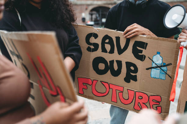 istock People are holding banner signs while they are going to a demonstration against climate change 1345174194