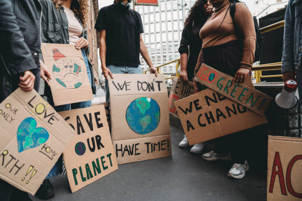 istock People are holding banner signs while they are going to a demonstration against climate change 1345174248