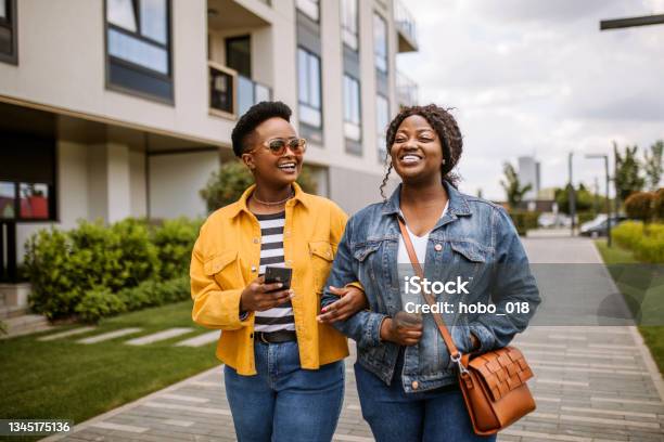 Two Tourist Girls In A City Walk On Sunny Summer Day Stock Photo - Download Image Now