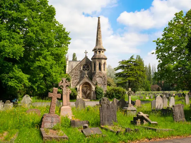 Photo of Old chapel and gravestones in a cemetery