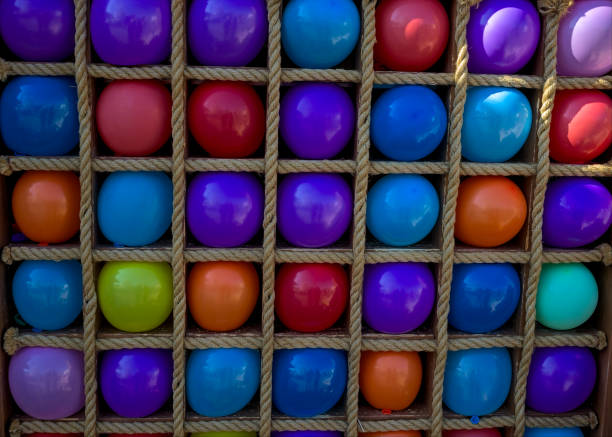 many colorful balloons in square cages for playing darts. - rubber dart imagens e fotografias de stock