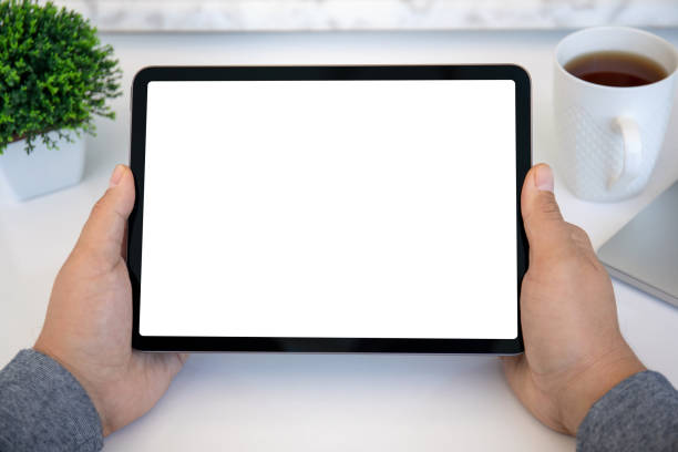 istock male hands holding computer tablet with isolated screen in office 1345180970