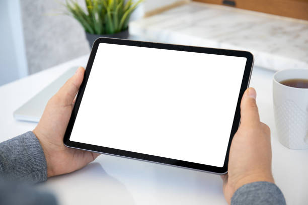 istock male hands holding computer tablet with isolated screen in office 1345181942