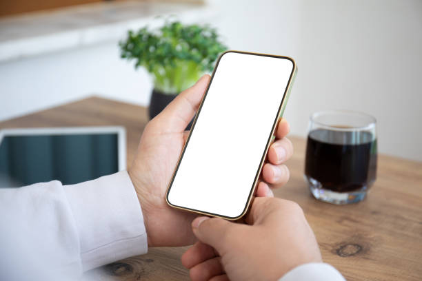 istock male hands holding phone with isolated screen in cafe 1345182054