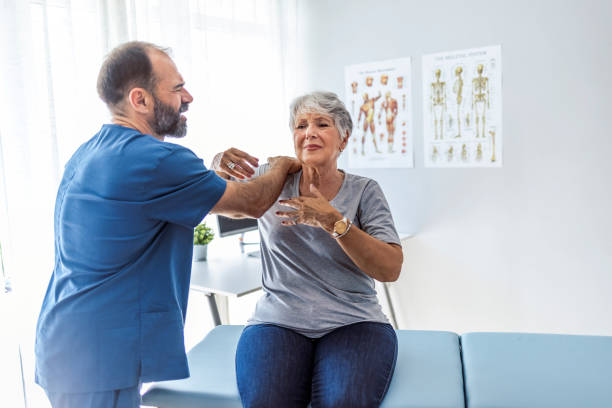istock Male doctor is examining her shoulder 1345182247