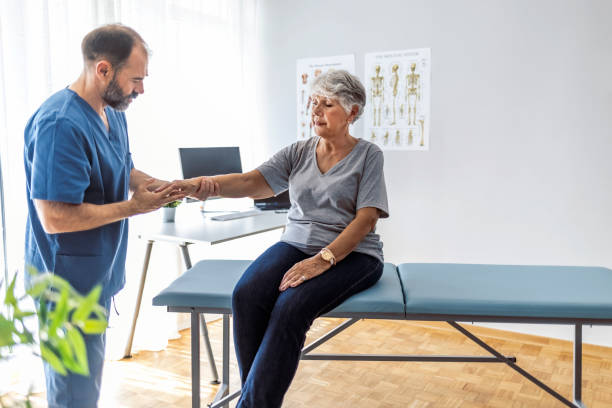 Physical Doctor consulting with patient arm problems