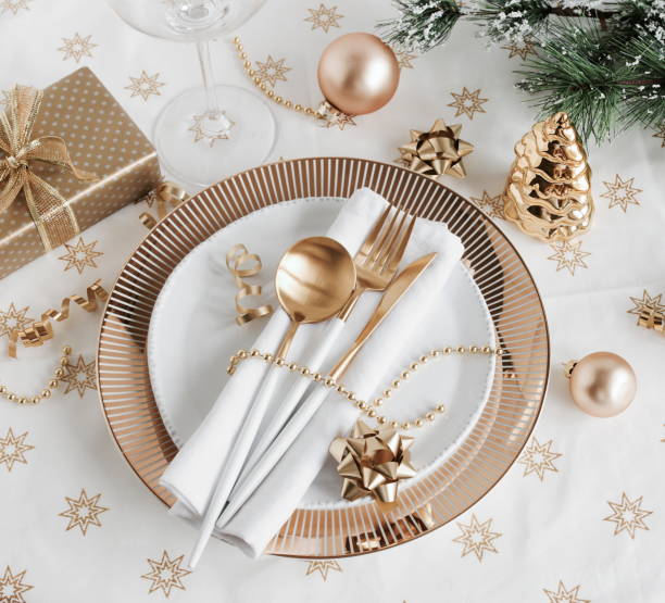 istock Christmas or New Year table setting with white golden cutlery 1345182904