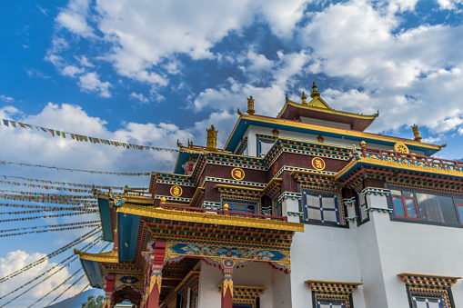 Sichuan, China - Aug 18, 2016. A monk using prayer wheels at Yarchen Gar in Sichuan, China. Yarchen Gar is the largest concentration of nuns and monks in the world.