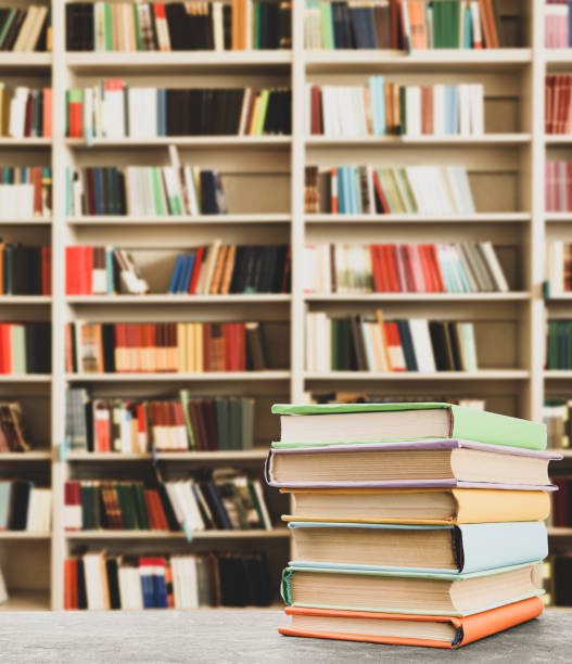 istock Stack of colorful books on table in library, space for text 1345184575