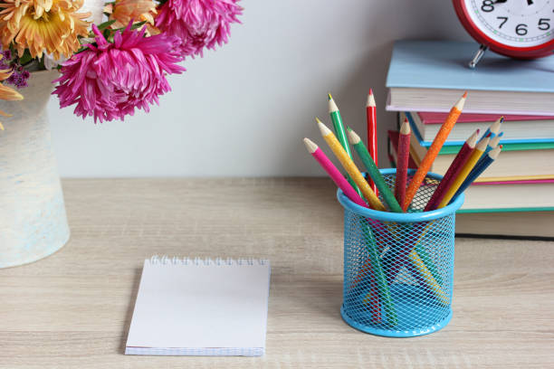 istock school still life with pencils textbooks and a bouquet 1345184842