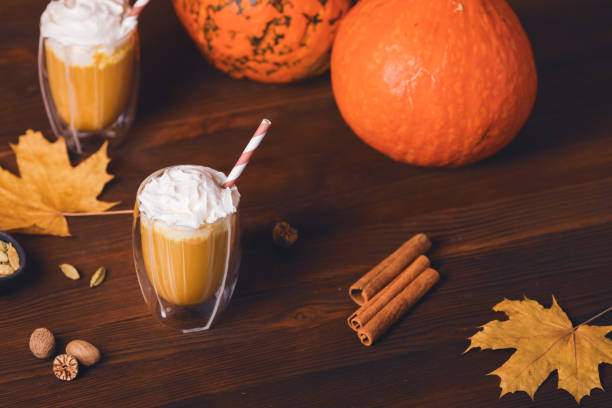 istock Pumpkin spice lattes on dark wooden table 1345186245
