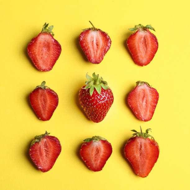 istock Tasty ripe strawberries on yellow background, flat lay 1345186872