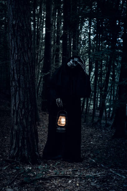 istock Funny Grim Reaper in the forest. 1345187779