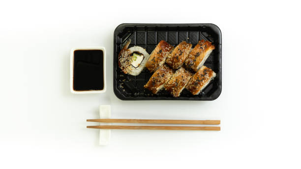 sushi delivery box on white background. japan menu in black transport box - plastic poppy imagens e fotografias de stock