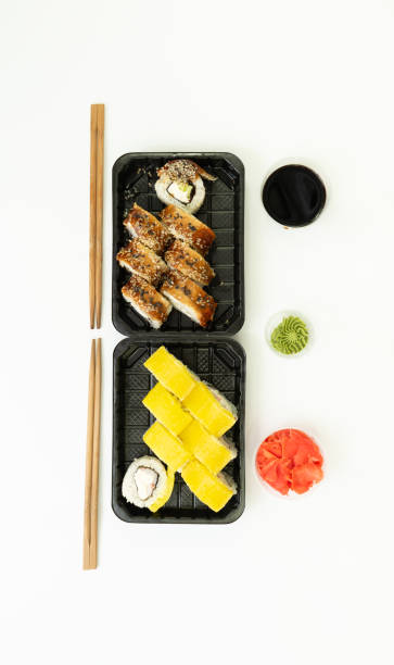 sushi delivery box on white background. japan menu in black transport box - plastic poppy imagens e fotografias de stock