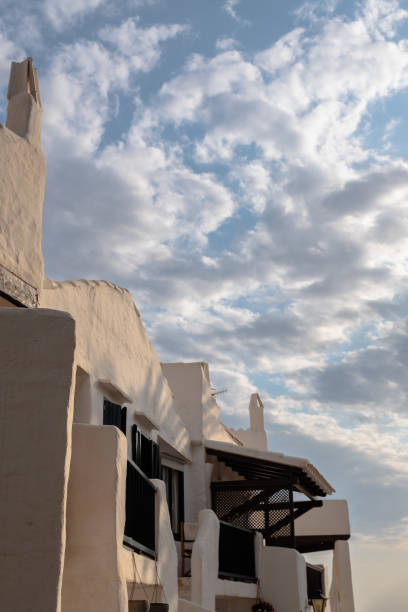 istock White buildings apartments under a cloudy sky 1345189335