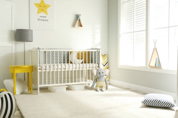 istock Cute baby room interior with crib and big window 1345191205