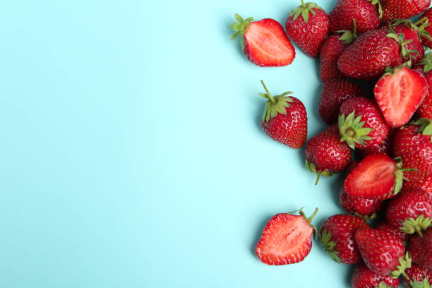 istock Tasty ripe strawberries on light blue background, flat lay. Space for text 1345191625