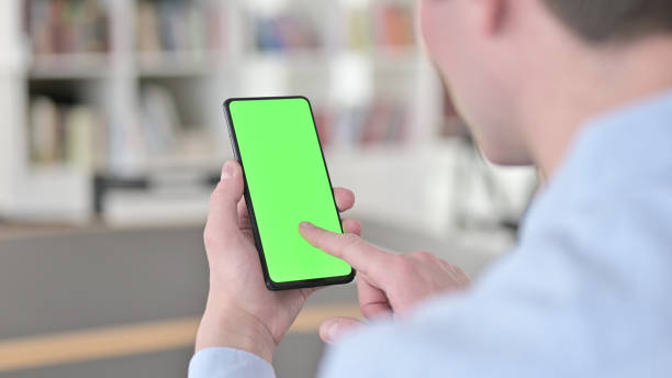 istock Man Clicking Chroma Key Smartphone Screen 1345191639