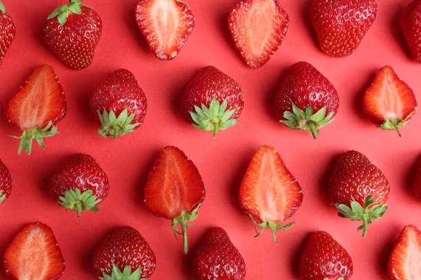 istock Tasty ripe strawberries on red background, flat lay 1345191765