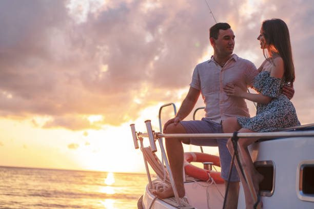 istock Beautiful couple looking at sunset from the yacht 1345192595