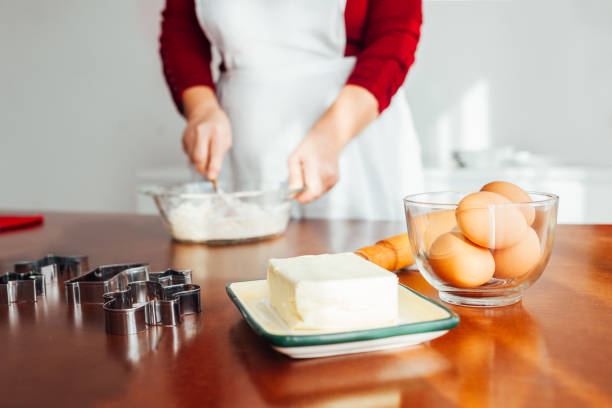 Woman preparing Christmas Cookies at home.
