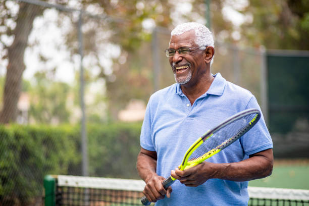istock Senior Black Man Playing Tennis 1345193732