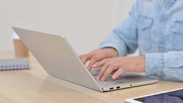 istock Close up of Man Typing on Laptop 1345193908