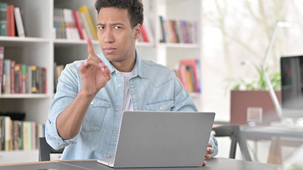 istock No, Young African American Man Rejecting by Finger Sign at Work 1345194026