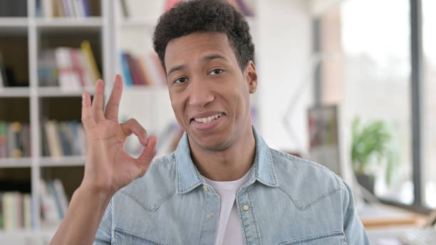 istock Ok Sign by Content Young African American Man 1345194108