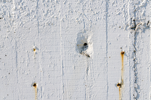 Damaged white concrete texture with bullet holes. Shot with a 35-mm full-frame 61MP Sony A7R IV.