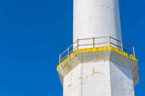 Red and white lighthouse under morning light