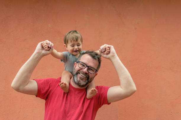 Father and his little son having fun in summer park