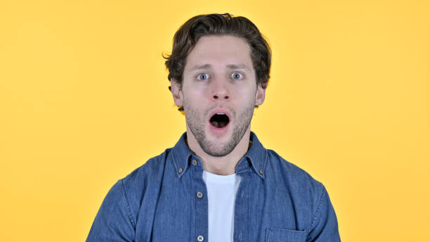 istock Disappointed Young Man having Loss, Yellow Background 1345195666