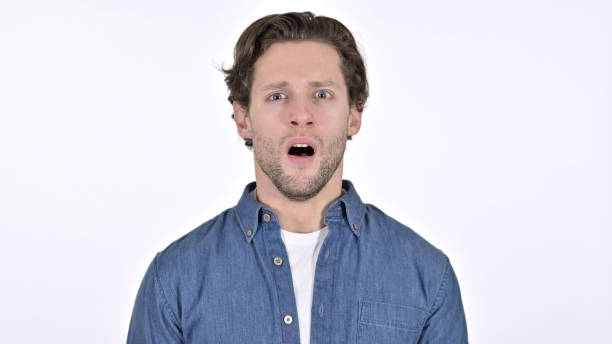 istock Stunned Young Man Feeling Shocked on White Background 1345196801