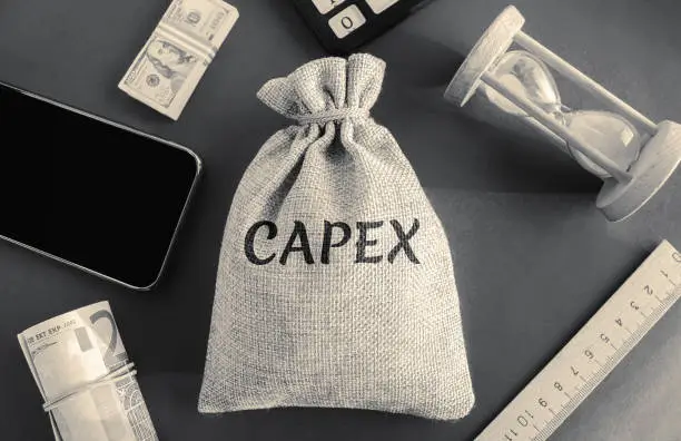 Photo of Money bag with the word Capex ( capital expenditure). Capital used by companies to acquire or upgrade physical assets. Business management concept