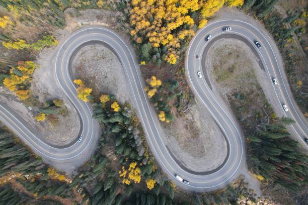 Top Down Drone View Of S-Curve Road Aerial view looking down from above on a two lane road as it winds in a spectacular S-curve through a mountain pass. Taken along Million Dollar Highway in Colorado. ridgway stock pictures, royalty-free photos & images