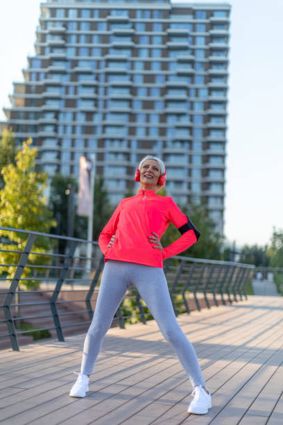 istock Senior athletic woman stretching outside 1345207575