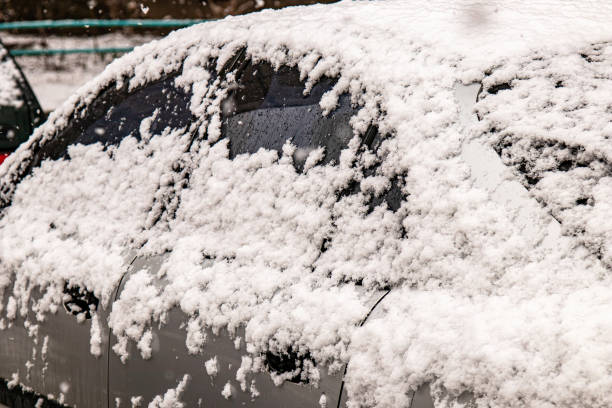 istock Car covered with snow in the winter blizzard.Extreme snowfall 1345207641