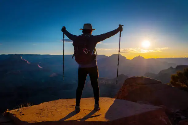 Female hiker enjoying the sunrise on the South Kaibab trail of the Grand Canyon.