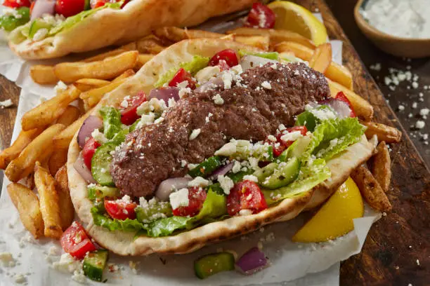 Beef Kofta Pita Wrap with Red Onions, Green Peppers, Tomatoes, Feta and Tzatziki SAuce