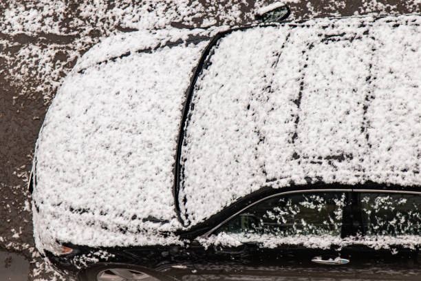 istock Car covered with snow in the winter blizzard.Extreme snowfall 1345208445