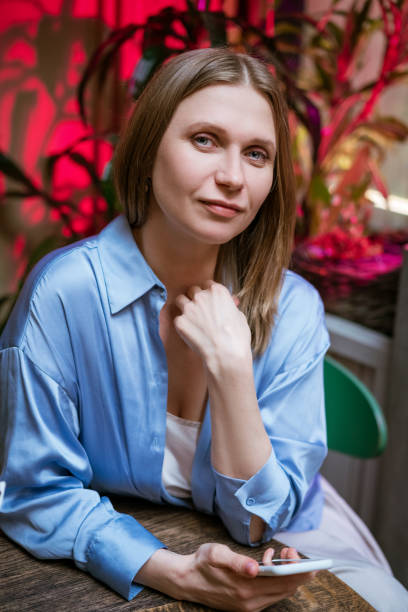 istock Pretty woman at a table in a cafe 1345209963
