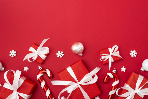 istock Christmas composition on red background. Red gift boxes with Christmas decorations. Top view. Flat lay 1345210140
