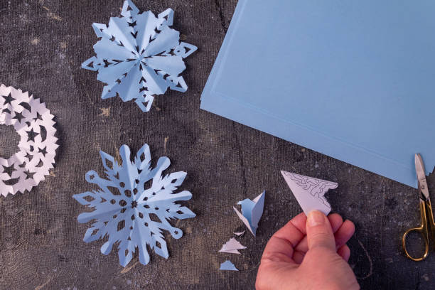 istock the process of making paper snowflakes 1345210725