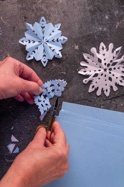 istock the process of making paper snowflakes flat lay 1345210726